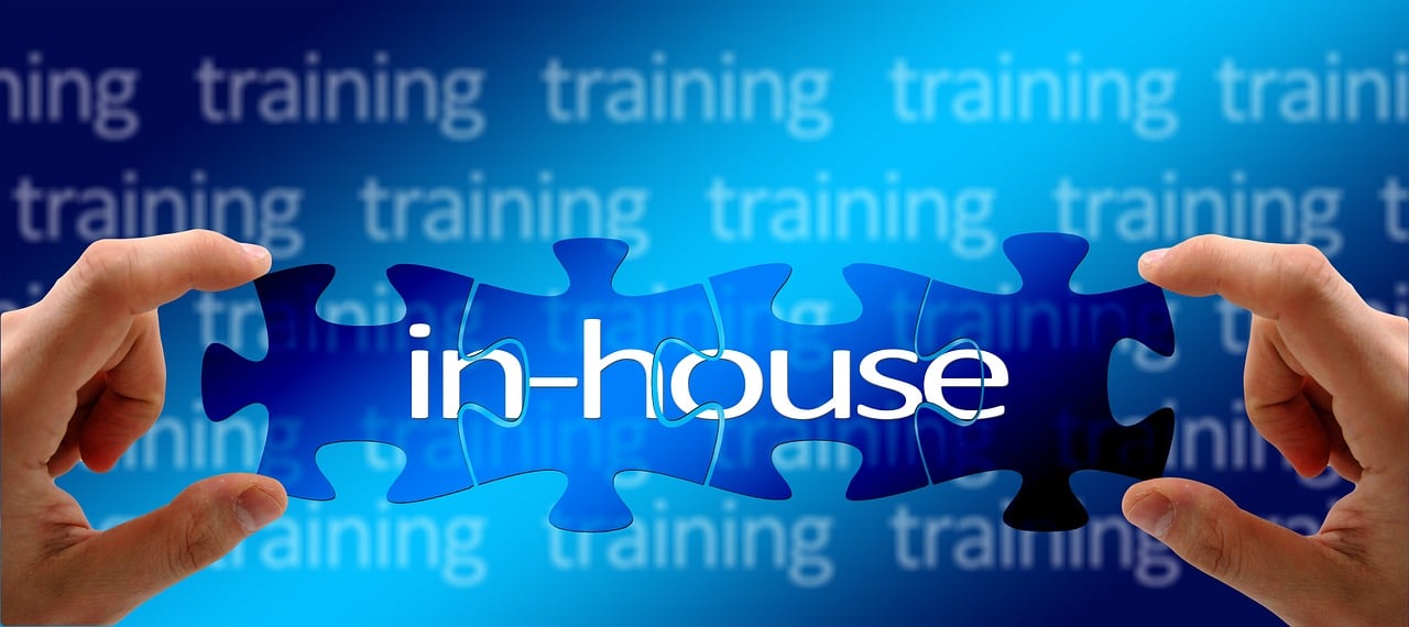 two hands holding a puzzle piece with the word in - house on it, a digital rendering, training, indigo, set photo, an illustration