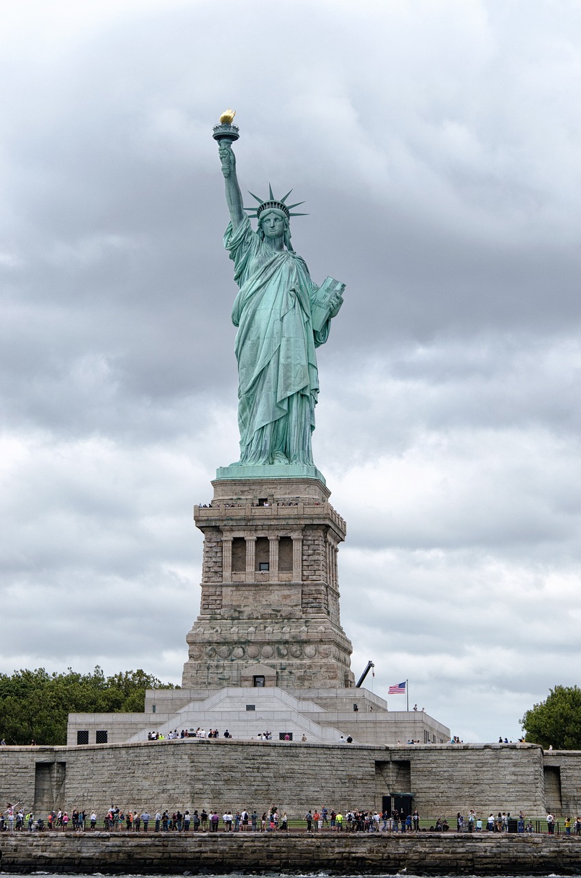 a statue of liberty in the middle of a body of water, a statue, overcast weather, photograph taken in 2 0 2 0, front top side view, usa-sep 20