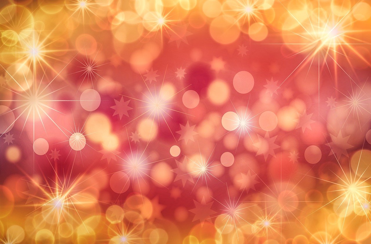 a close up of a blurry background with stars, by Marie Bashkirtseff, shutterstock, red and yellow color scheme, christmas, istockphoto, radiant flares