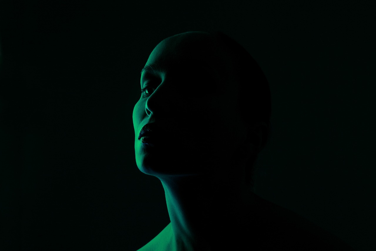 a close up of a person in a dark room, a portrait, by Anna Füssli, green neon, profile posing, low angle photo, backlight glow