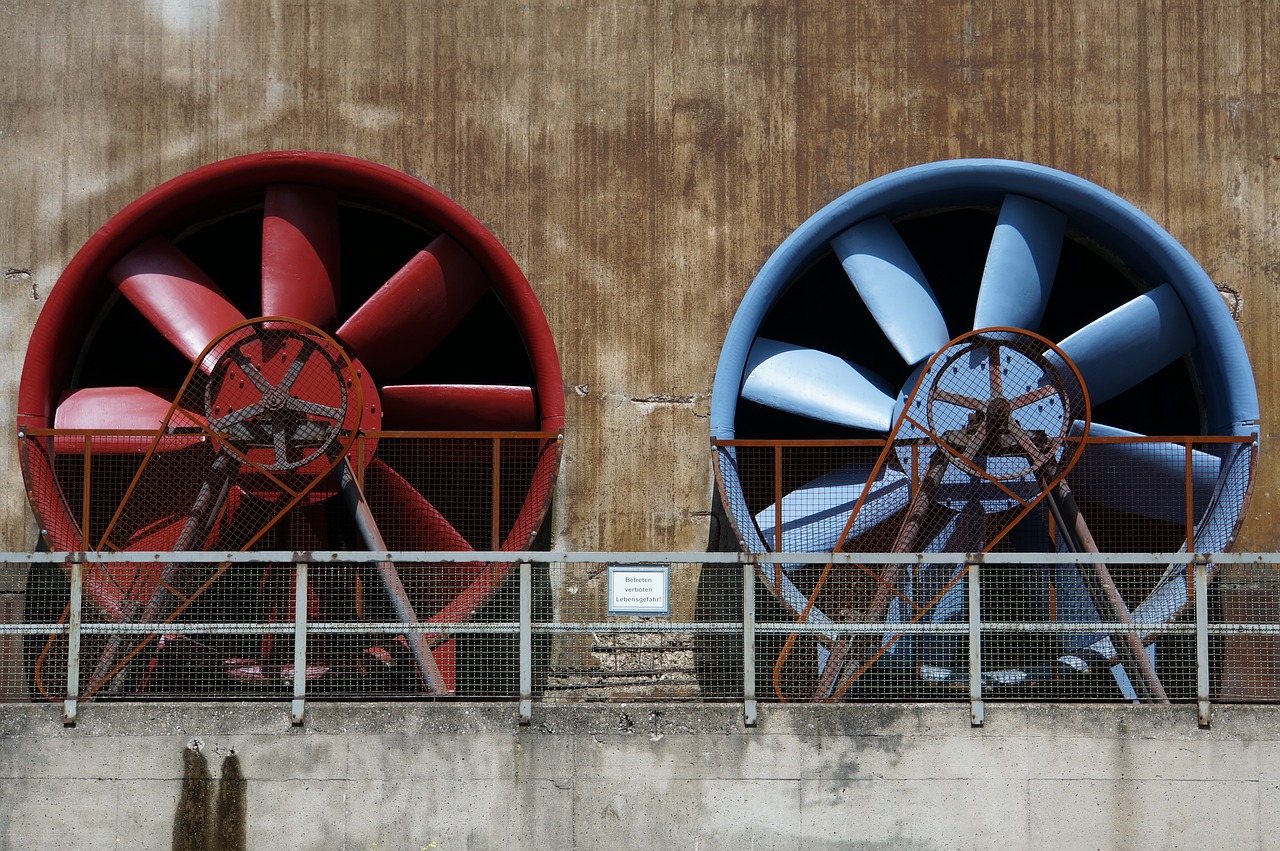 a couple of red and blue fans on the side of a building, flickr, water reservoir, industrial photography, thrusters, photograph credit: ap
