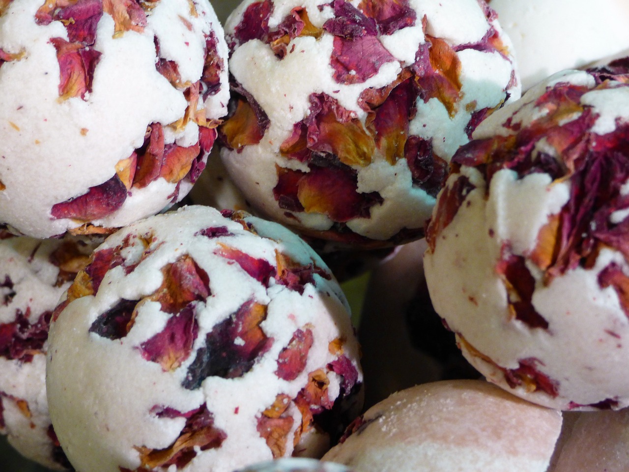 a close up of a bunch of balls of food, inspired by Balázs Diószegi, process art, rose petals, vanilla, infused with a dream, bath
