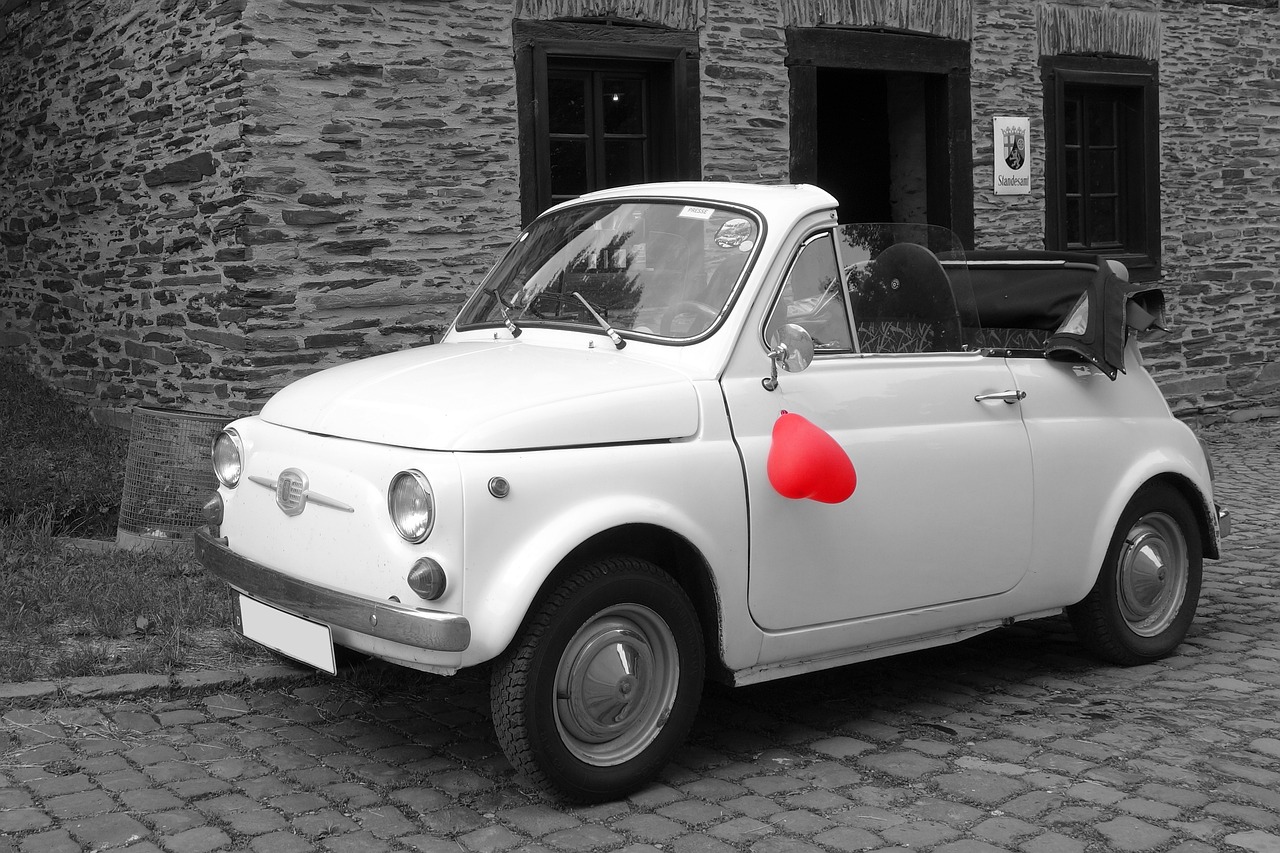 a small white car with a red heart painted on it, inspired by Hendrick Cornelisz Vroom, flickr, black and white color only, servando lupini, mario in real life, sfw version