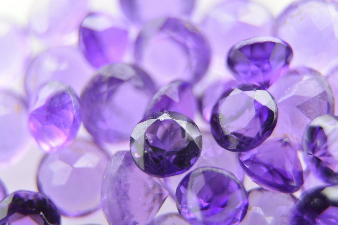 a pile of purple glass beads sitting on top of a table, pexels, crystal cubism, detailed product photo, “diamonds, close-up product photo, multiple purple halos
