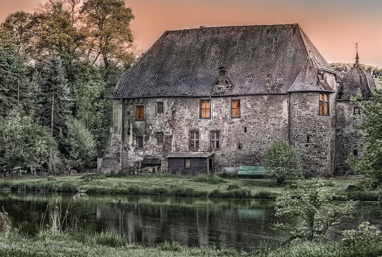 a large stone building next to a body of water, by Karl Hagedorn, pixabay contest winner, tonalism, 1 8 8 0 s big german farmhouse, pink golden hour, abandoned factory, portrait!!!!