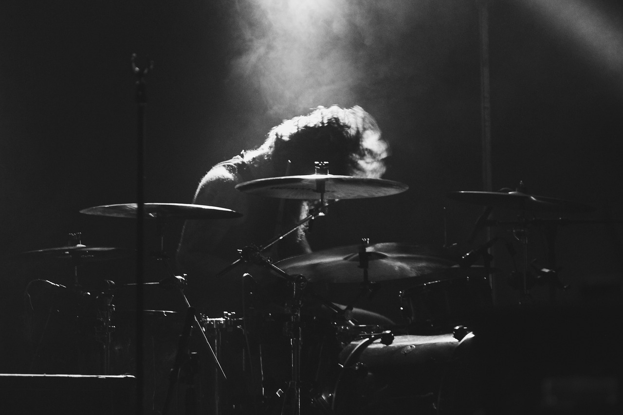 a black and white photo of a man playing drums, by Matija Jama, pexels, crystal castles, smoky lighting, profile image, illustration!