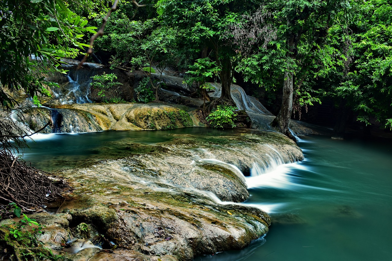 a stream running through a lush green forest, a picture, by Thomas Häfner, shutterstock, sumatraism, pools of water, bangkok, water fall, blue waters
