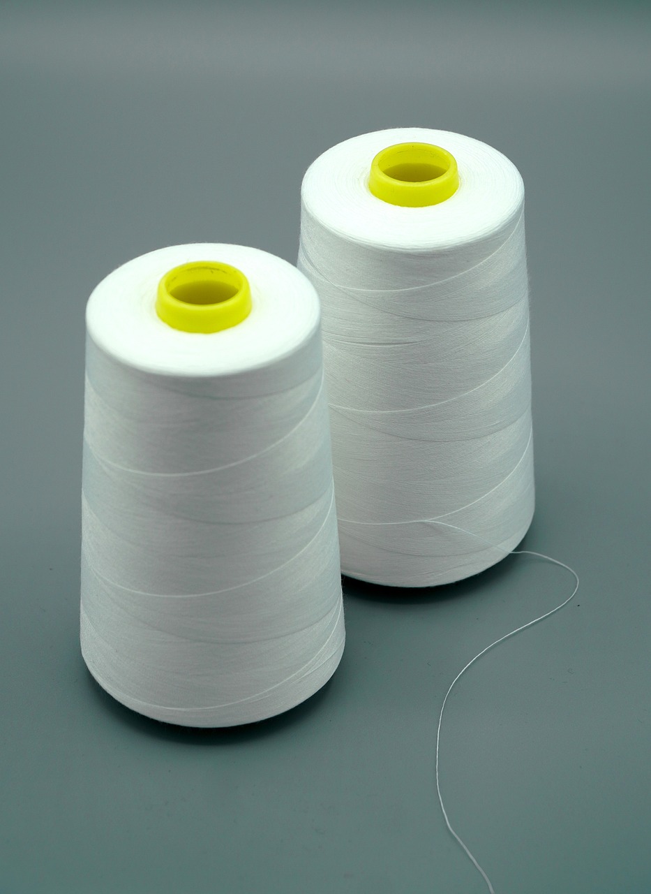 two spools of white thread on a gray surface, a picture, plasticien, product photograph, cone, whole-length, peak