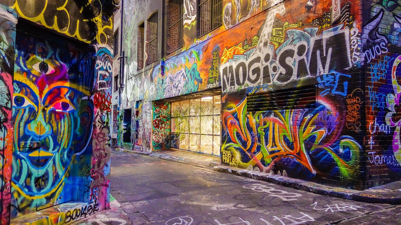 a street filled with lots of graffiti next to a building, by Mark English, pexels contest winner, australia, magical and mystical, vibrant but muted colors, ((oversaturated))