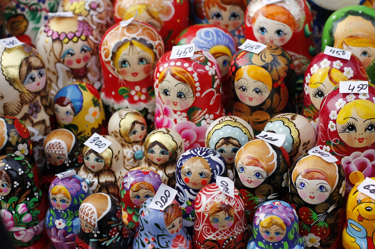 a bunch of dolls sitting on top of a table, by Serhii Vasylkivsky, toyism, tourist destination, ap photo, a wooden, market