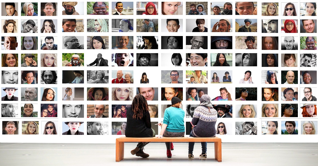 a couple of people that are sitting on a bench, a picture, trending on pixabay, visual art, diverse faces, photos of family on wall, endless collaboration with ai, in a gallery setting