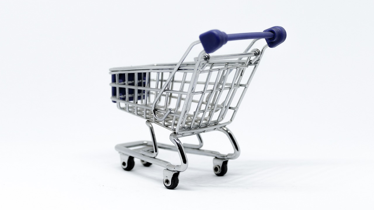 a miniature shopping cart on a white surface, dsrl photo, low resolution, high quality product image”