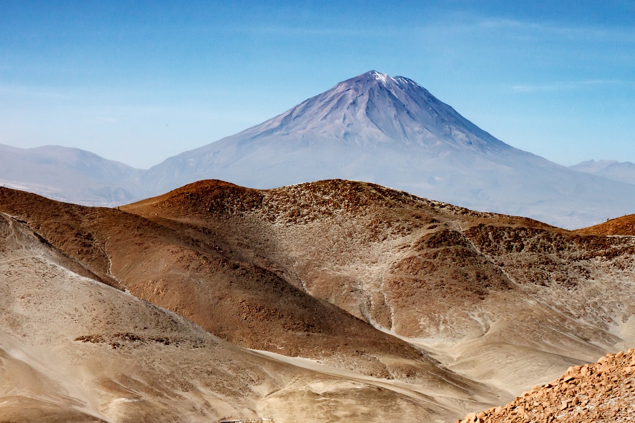 a person riding a horse in front of a mountain, by Juan O'Gorman, flickr, overlooking martian landscape, chile, high detail photo of a deserted, active volcano