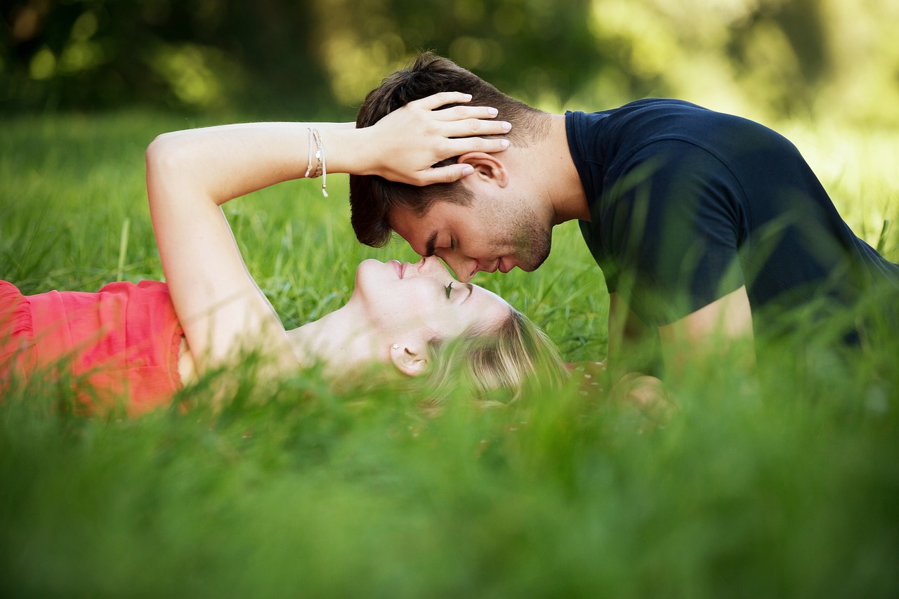 a man and a woman laying in the grass, a picture, lovely kiss, istockphoto, realistic photograph, eye contact