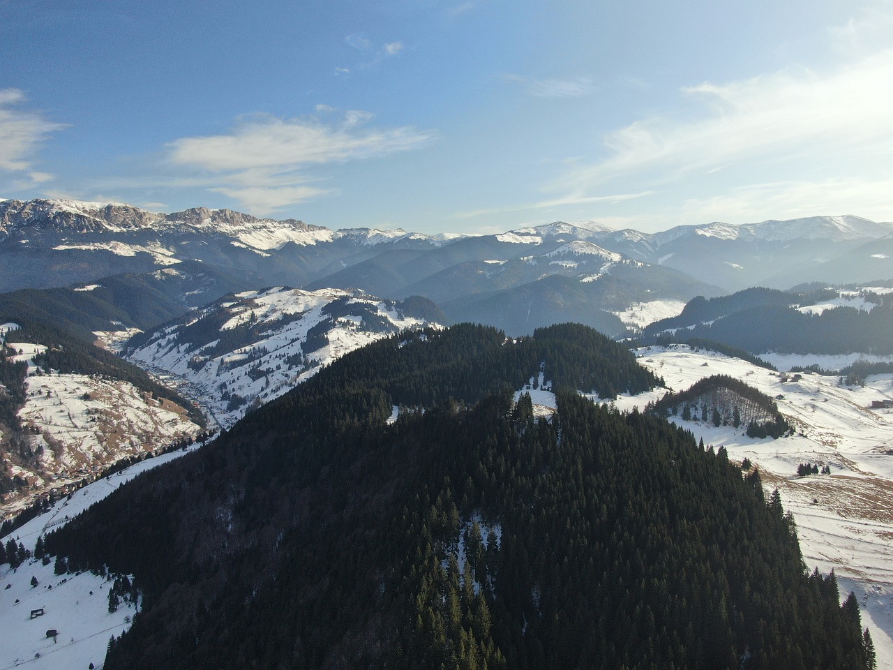 a view of a mountain range covered in snow, a picture, by Aleksander Gierymski, shutterstock, aerial footage, high angle uhd 8 k, transylvania, drone footage