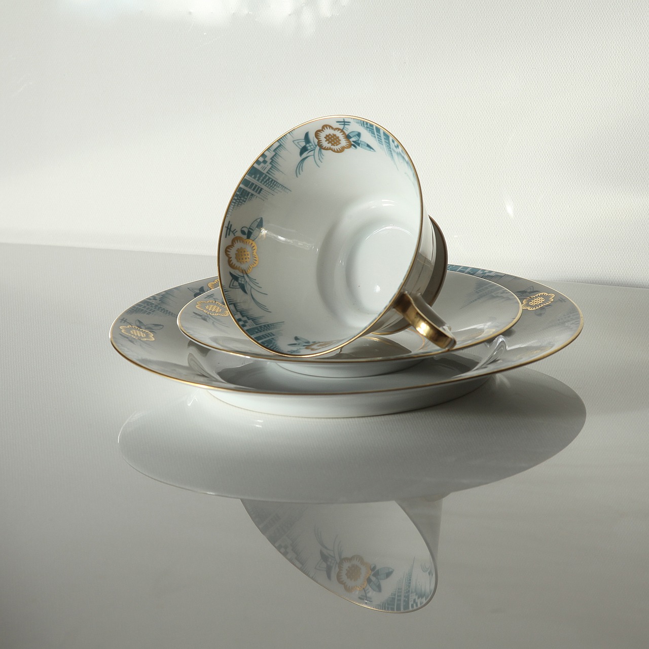 a close up of a cup and saucer on a table, inspired by Eugène Isabey, art deco, 7 0 mm photo