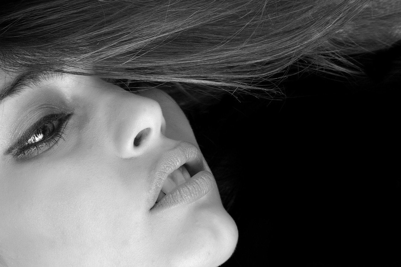 a black and white photo of a woman with long hair, trending on pixabay, neck zoomed in from lips down, color photograph portrait 4k, side view close up of a gaunt, hyperdetailed face