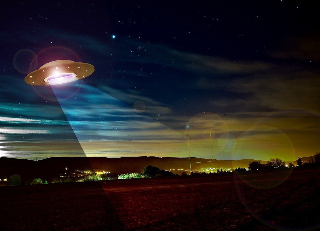 an alien flying over a field at night, a hologram, by Julian Allen, shutterstock, saturn, roswell air base, lights beam, photo-shopped