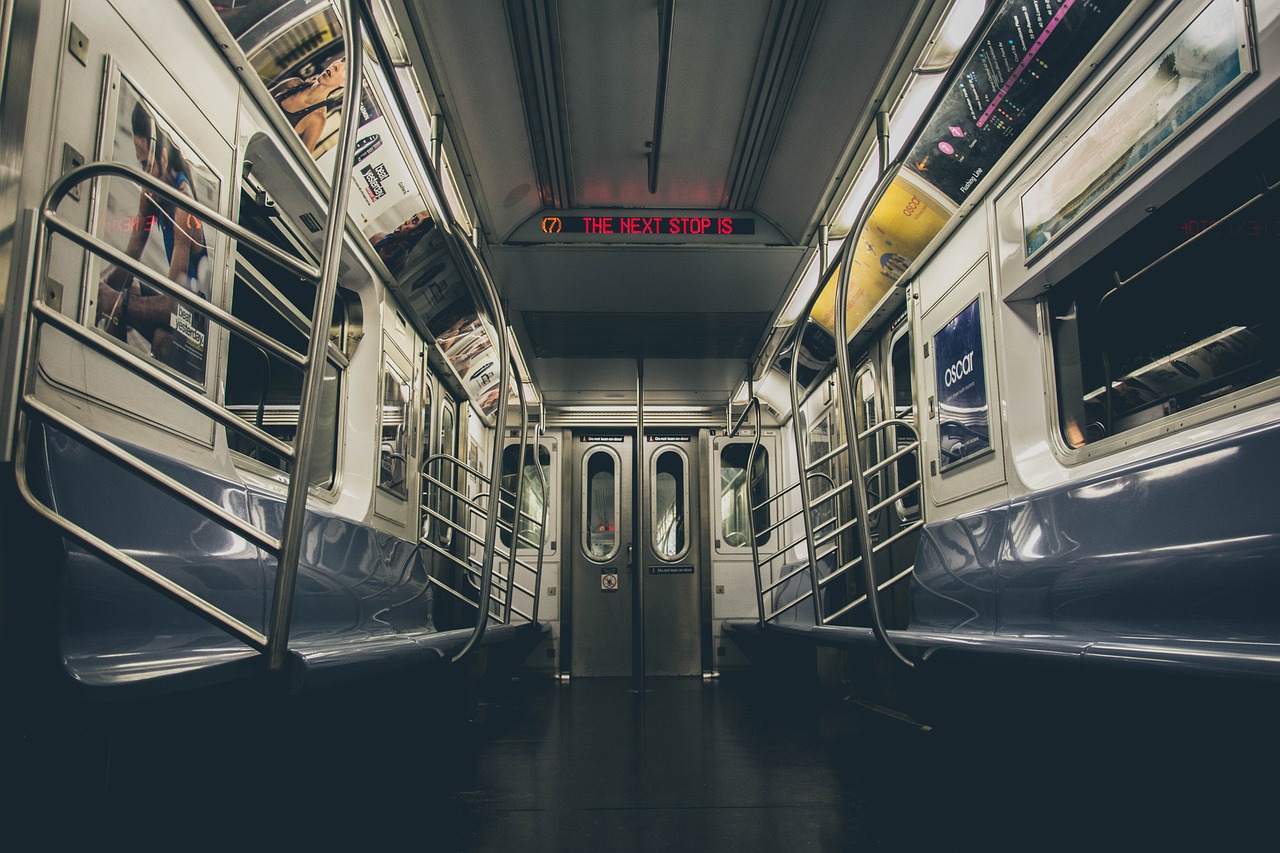 a view of the inside of a subway car, unsplash contest winner, nighttime!, in the middle of new york, sparsely populated, interesting background