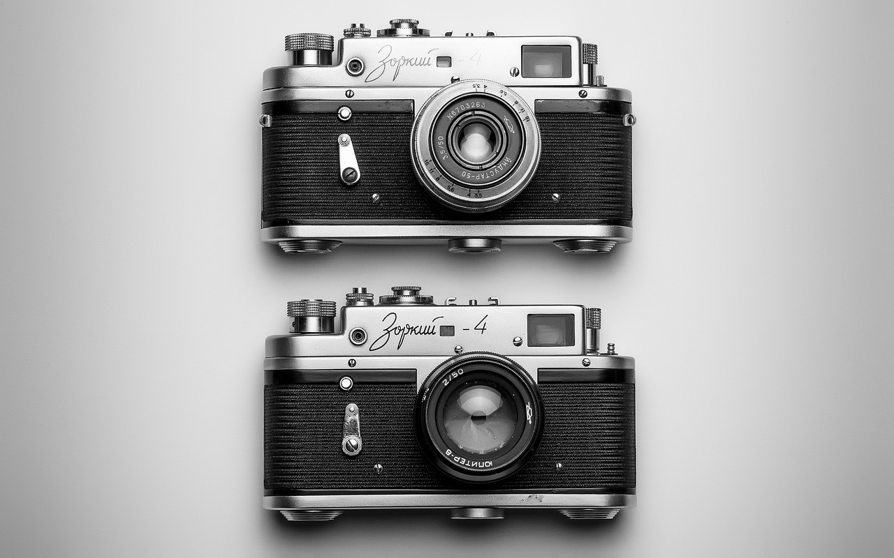 a black and white photo of two old cameras, by Eugeniusz Zak, commercial product photography, hyperealistic photo, color photo, perfect symmetrical image