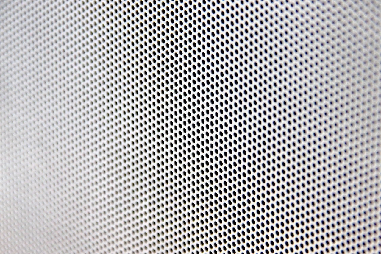 a close up of a piece of metal mesh, inspired by Bridget Riley, computer art, front left speaker, white with black spots, modern high sharpness photo