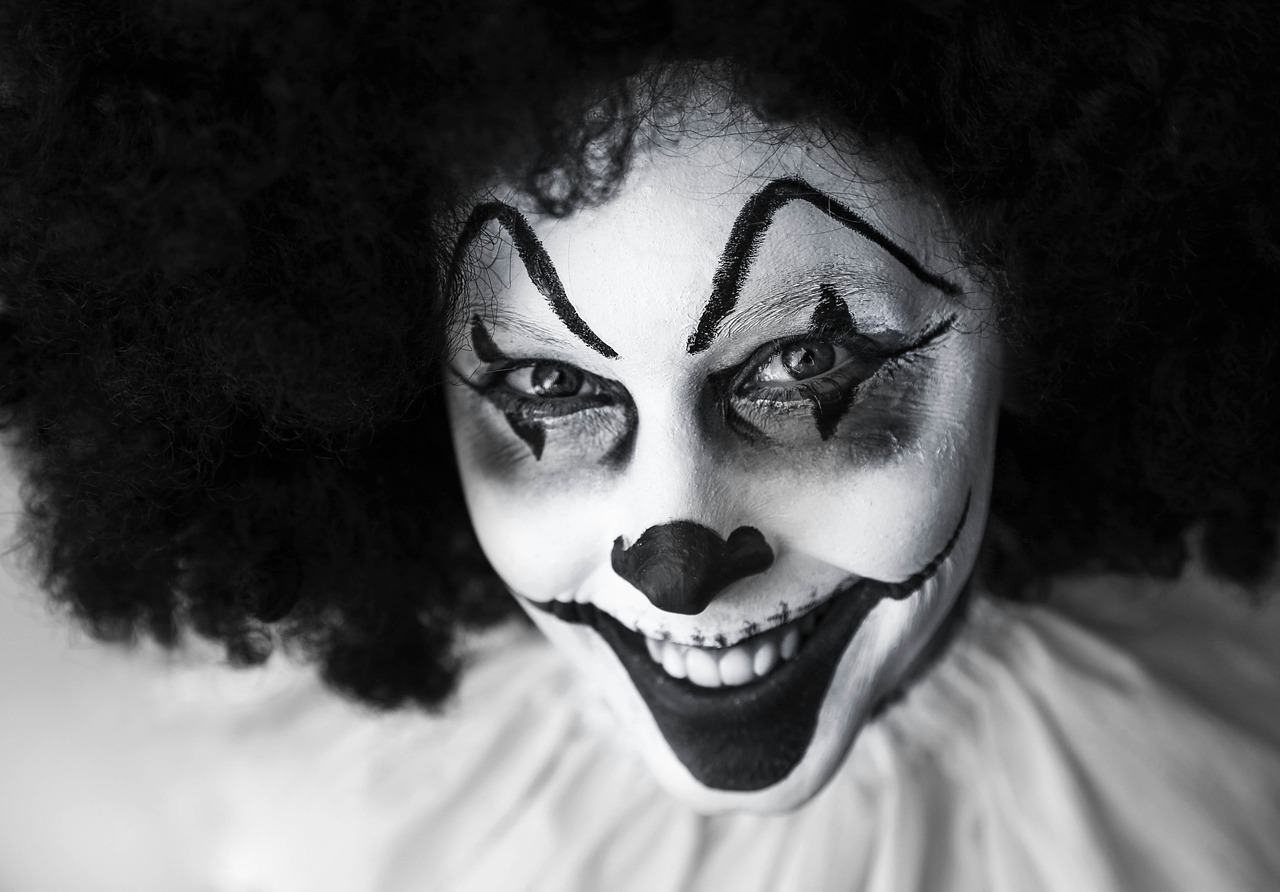 a close up of a person with a clown makeup, a portrait, by Edward Corbett, pexels, realistic black and white, getty images, halloween, welcome to the circus