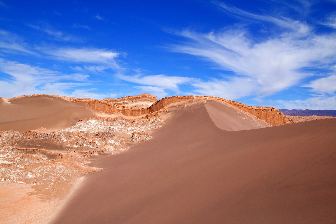 a person riding a snowboard on top of a sand dune, a pastel, by Niklaus Manuel, shutterstock, color field, chiseled formations, ancient”, andes, very beautiful photo