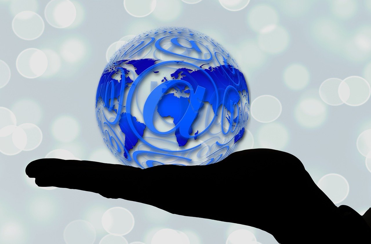 a person holding a glass globe in their hand, by Tom Carapic, pixabay, digital art, in front of the internet, stylized silhouette, email, stock photo
