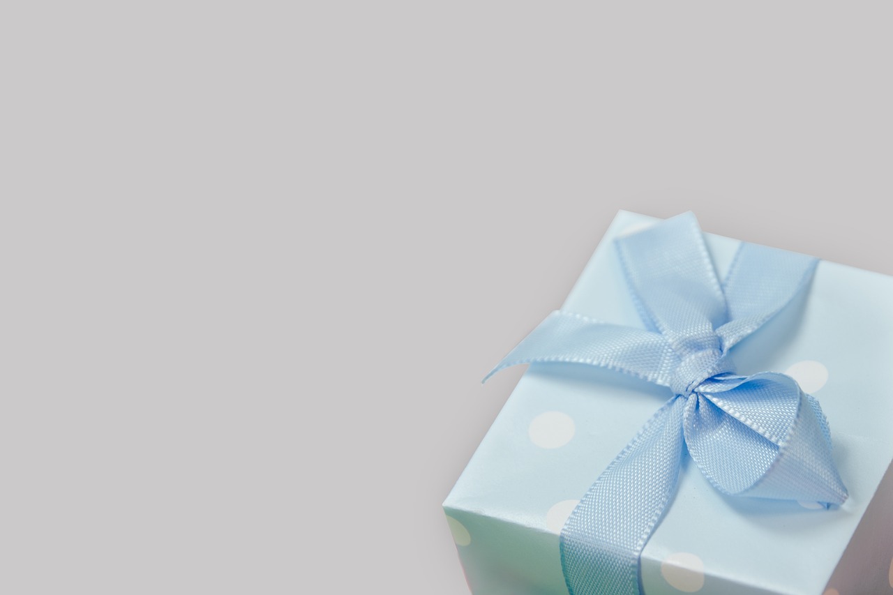 a small blue gift box with a blue bow, by Emma Andijewska, asset on grey background, banner, polka dot, background image