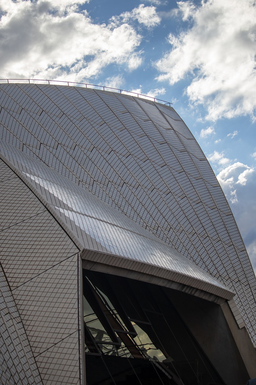 a close up of a building with a sky background, inspired by Sydney Carline, modernism, dragon scales across hairline, concert hall, 8k 50mm iso 10, back arched