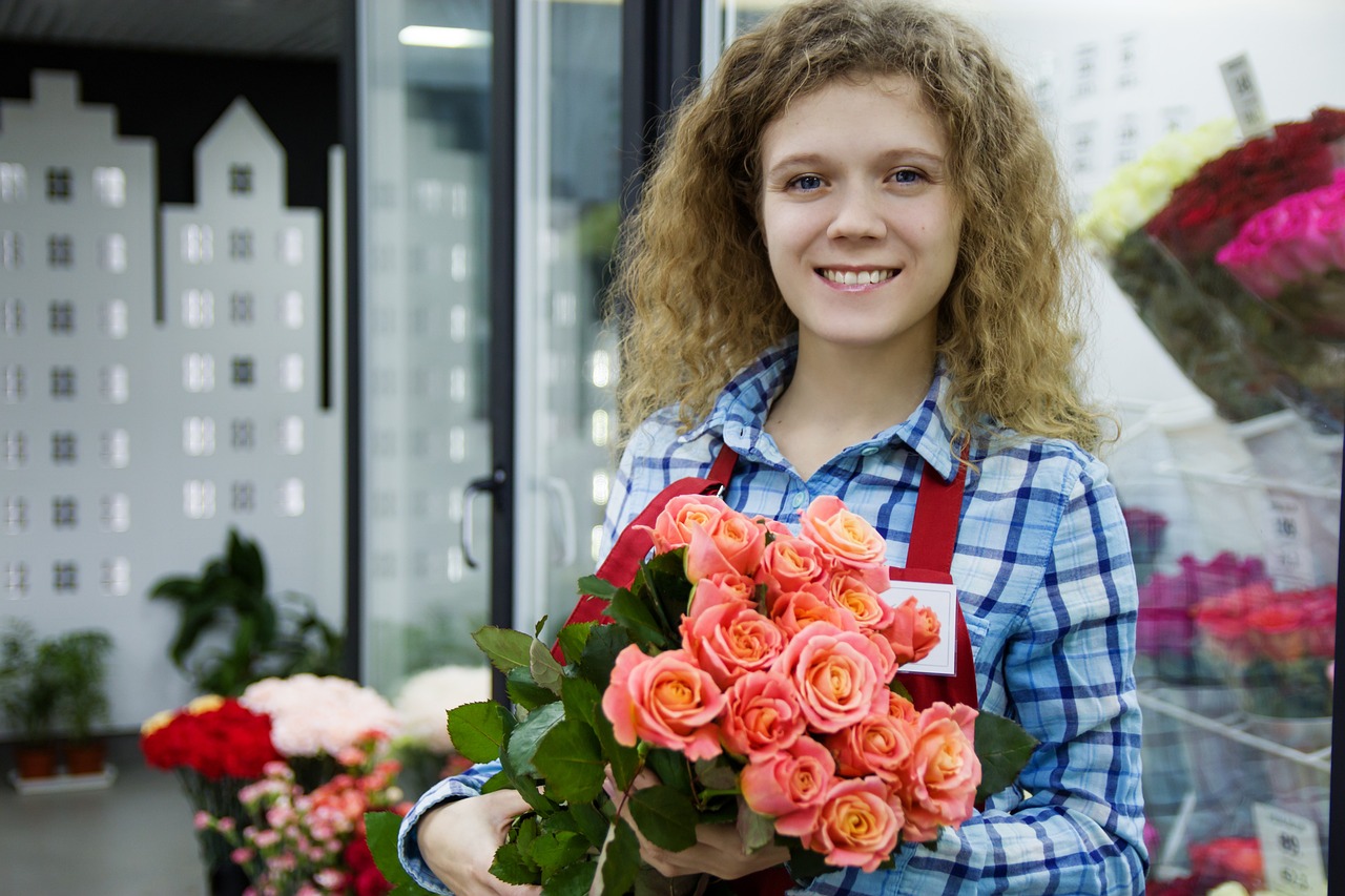 a woman holding a bunch of pink roses, by Maksimilijan Vanka, shutterstock, wearing overalls, flower shop scene, 1 6 years old, group photo