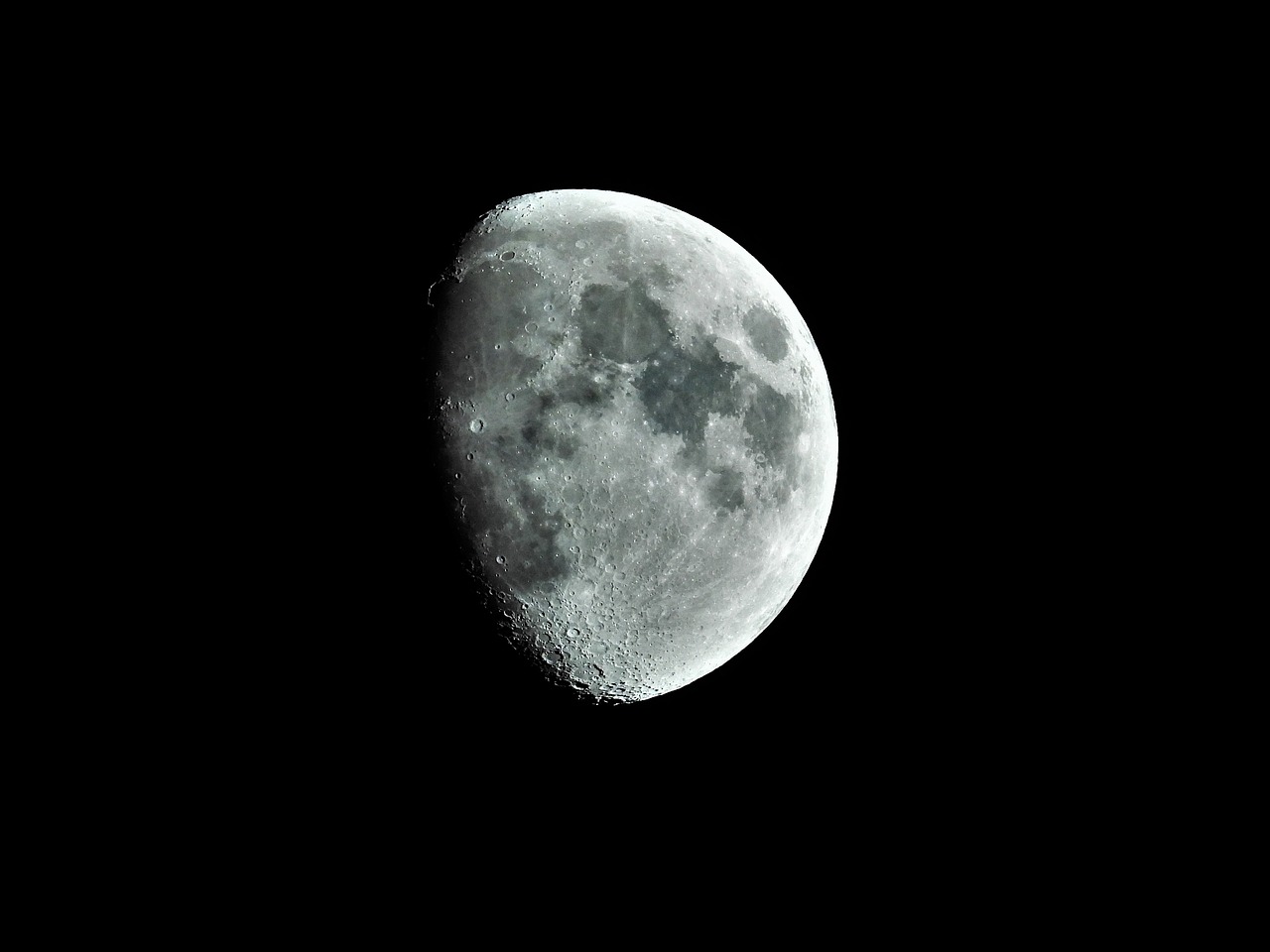 the moon is lit up in the dark sky, a macro photograph, inspired by John Moonan, flickr, extremely high contrast!, craters, corner, half - length photo