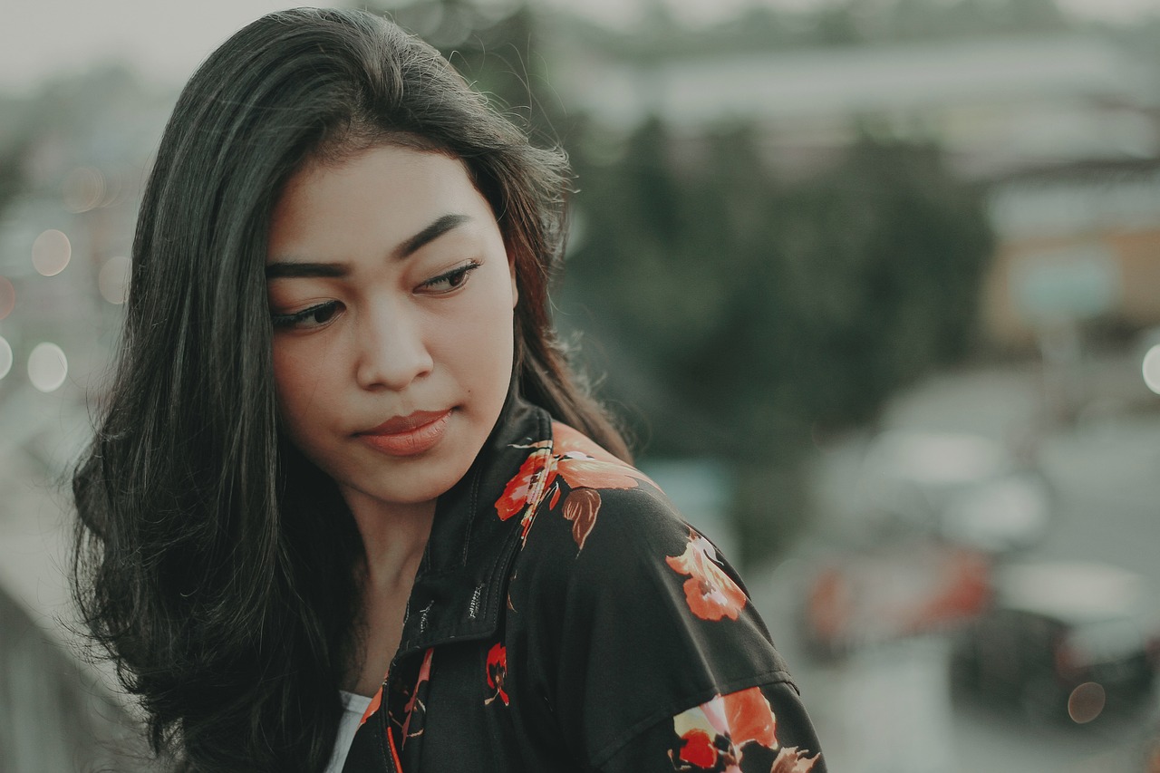 a close up of a person wearing a jacket, a picture, tumblr, vietnamese woman, with a sad expression, focus on girl, floral