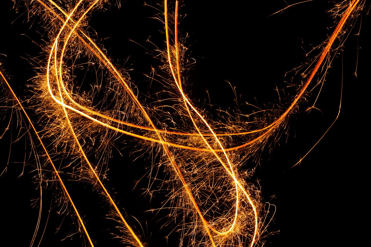 a close up of a sparkler on a black background, a microscopic photo, digital art, golden curve structure, hd —h 1024, orange neon backlighting, strings background