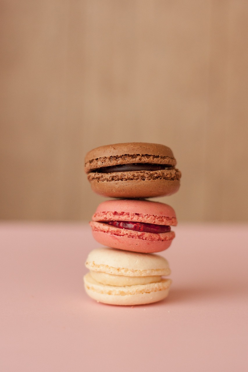 three macarons stacked on top of each other, by François Girardon, unsplash, brown and magenta color scheme, soft red tone colors, portrait 4 / 3, 2 0 1 0 s