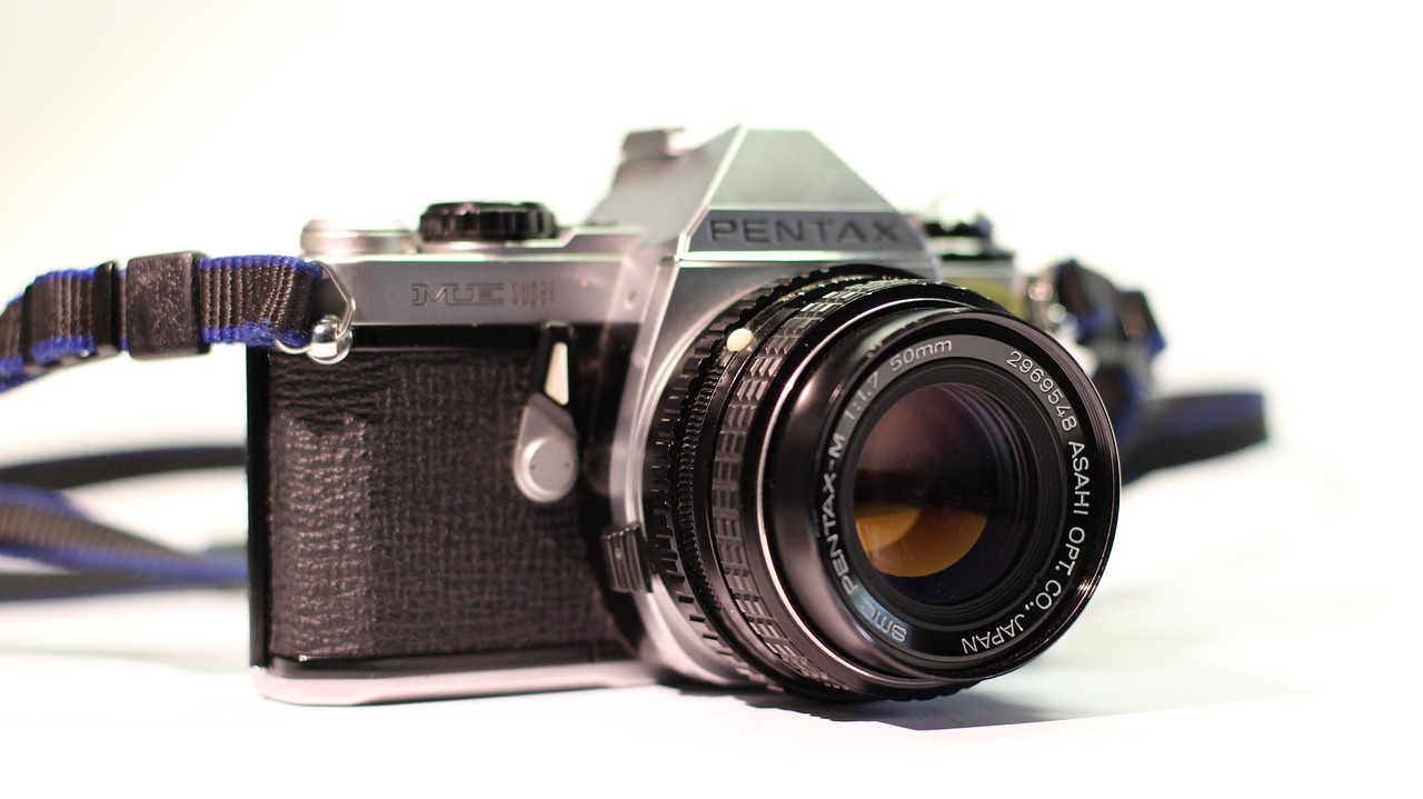 a close up of a camera with a strap, by Adam Rex, flickr, photorealism, on pentax 67, 1 9 7 0 colour photography, depth of field!