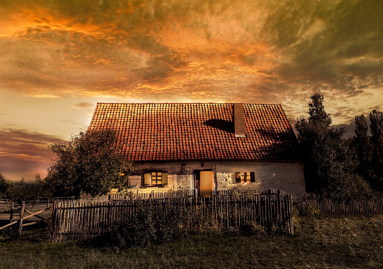 a house sitting on top of a lush green field, a picture, by Jozef Czapski, romanticism, red stormy sky, sky is orangish outside, old picture, village house