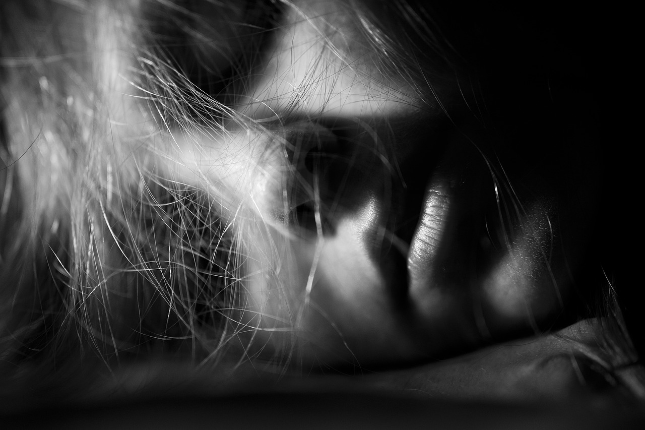 a black and white photo of a woman's face, by Eugeniusz Zak, pexels, hurufiyya, a portrait of a suicidal girl, extreme close up portrait, unkept hair, hiding