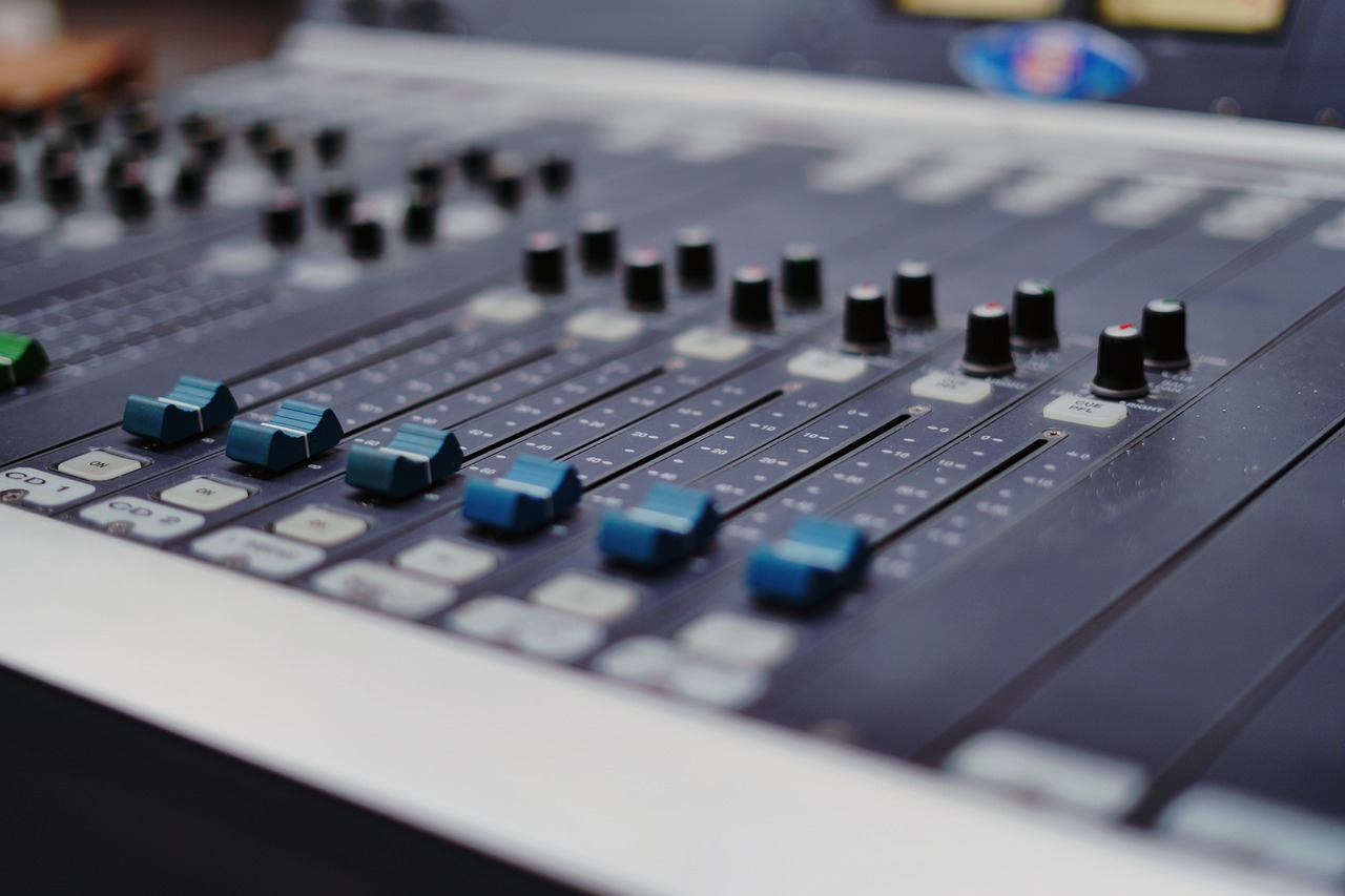 a close up of a sound board in a recording studio, by Ejnar Nielsen, shutterstock, realism, sports broadcast, stock photo, 🎨🖌️, blue color grading