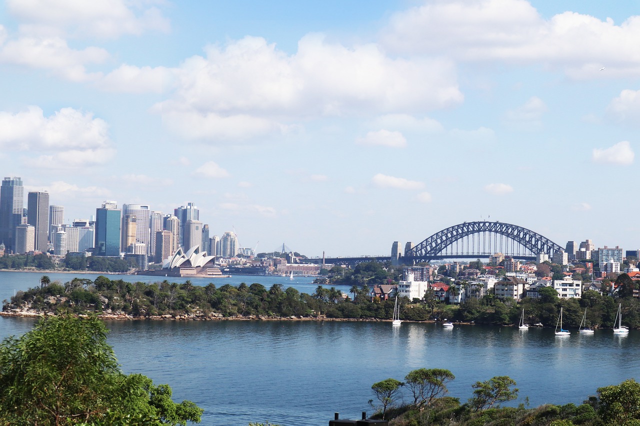 a large body of water with a bridge in the background, a picture, inspired by Sydney Carline, pexels, hurufiyya, panorama distant view, tony roberts, regular sized, tropical coastal city