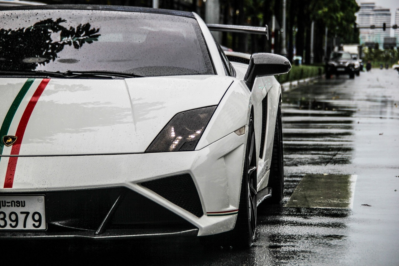 a white sports car parked on a wet street, a photo, tumblr, lamborghini, closeup shot, carbon, in the streets of tokyo