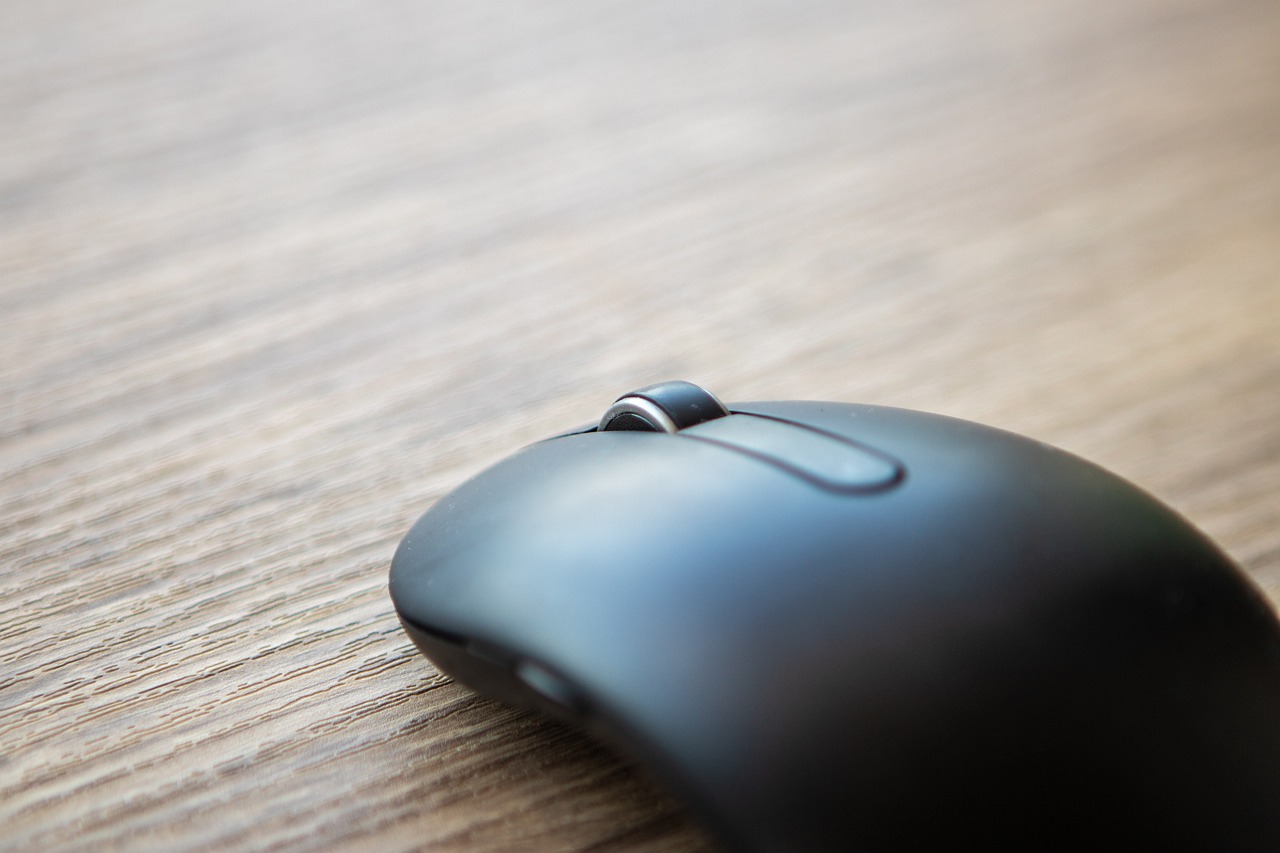 a computer mouse sitting on top of a wooden table, a macro photograph, close-up product photo, rounded, thin dof, 4 k product photo