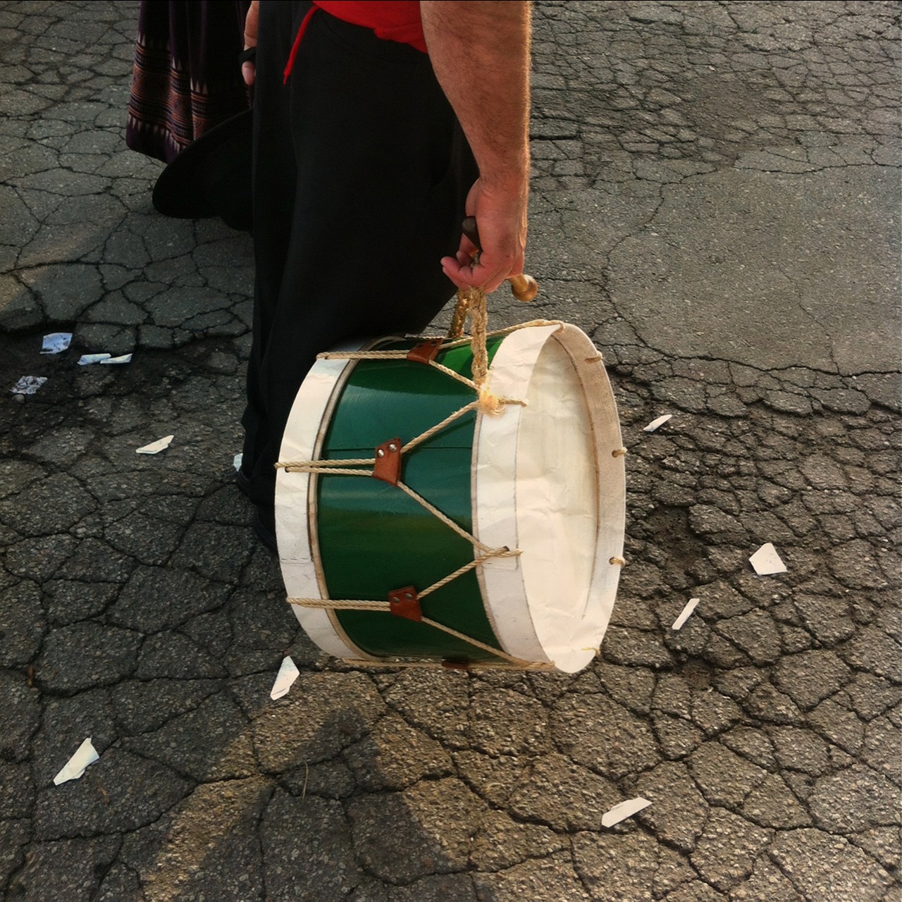 a person holding a drum on a street, by Whitney Sherman, reddit, walk in a funeral procession, california;, hungarian, 2014