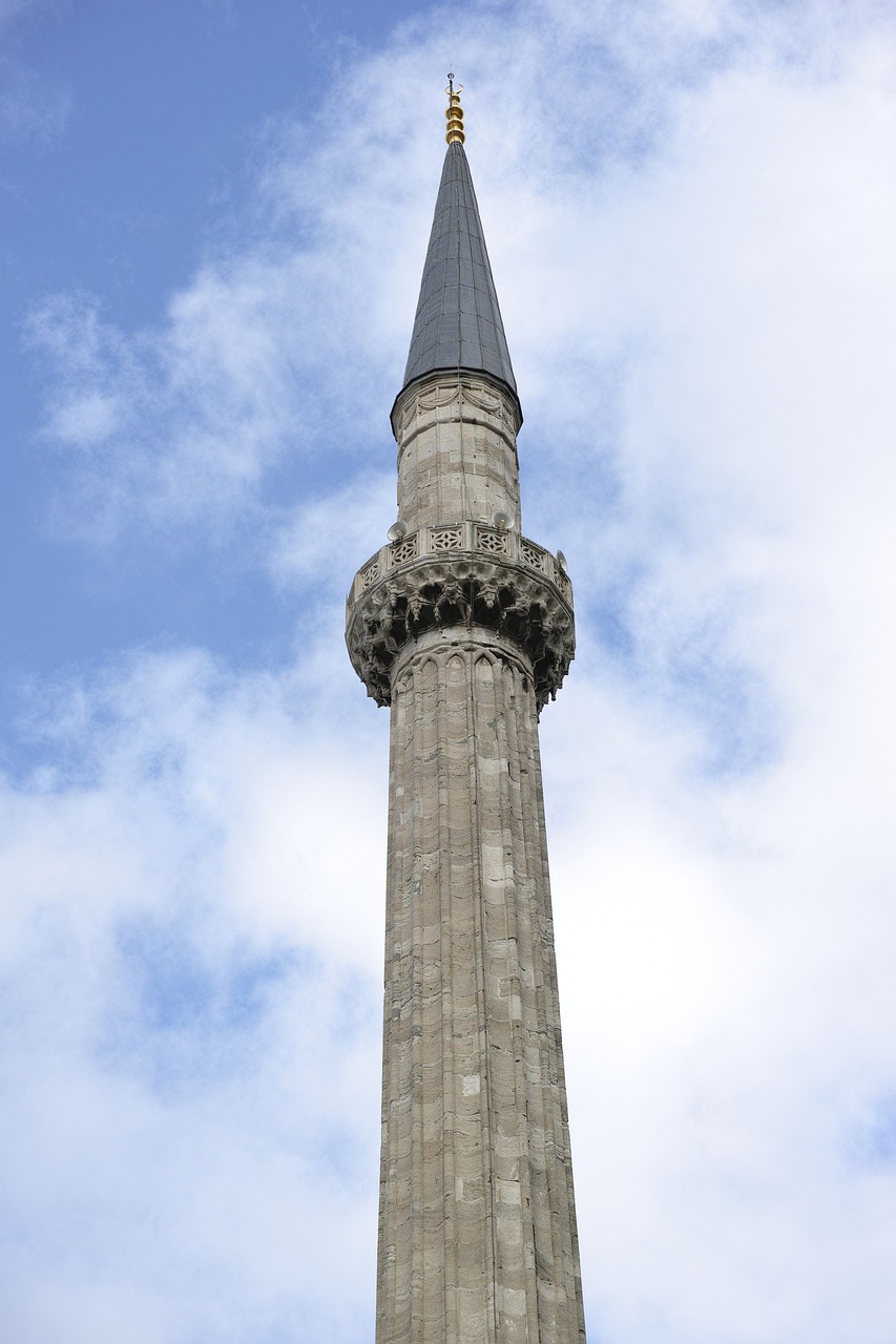 a tall tower with a clock on top of it, inspired by Fikret Muallâ Saygı, hurufiyya, low angle photo, cone shaped, stone, ottoman empire