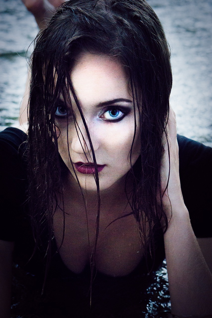 a beautiful young woman laying on top of a body of water, a portrait, inspired by Luis Royo, gothic art, closeup headshot, sigma 85/1.2 portrait, rainstorm, edited in photoshop