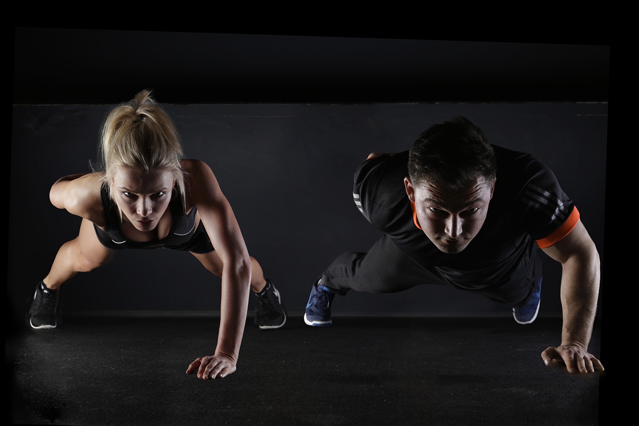 a man and a woman are doing push ups, a photo, by Micha Klein, shutterstock, figuration libre, hard lighting!, cool marketing photo, studio photo, high light on the left