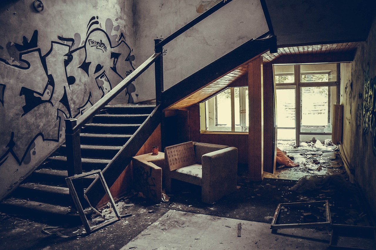 a living room filled with furniture and graffiti on the walls, by Sebastian Spreng, pexels, coming down the stairs, hospital interior, broken throne, old photo width 768