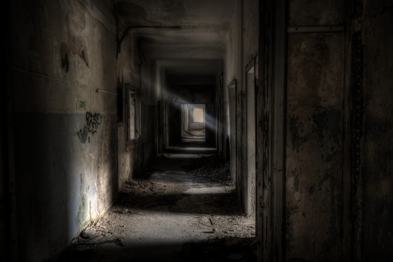 a dark hallway with graffiti on the walls, digital art, by Wolfgang Zelmer, shutterstock, decaying dappled sunlight, abandoned hospital, shadow cast of dark corridor, in the early morning