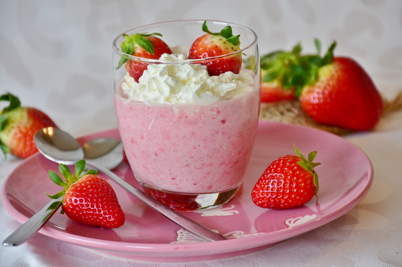 a pink plate topped with a dessert covered in whipped cream and strawberries, inspired by Wlodzimierz Tetmajer, pixabay, vanilla smoothie explosion, avatar image, bowl