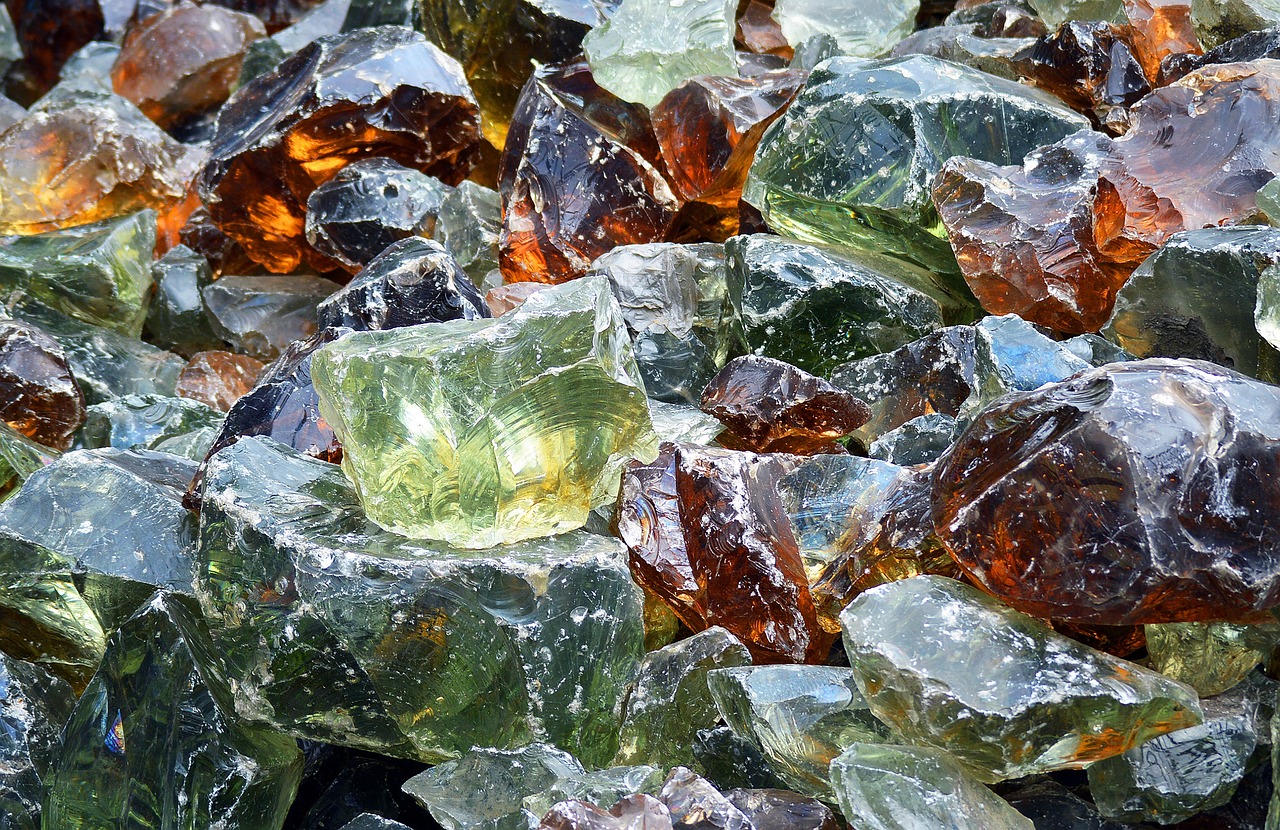 a pile of broken glass sitting on top of a table, by Jan Rustem, pixabay, orange rocks, translucent algae ornate, amber glasses, glacier